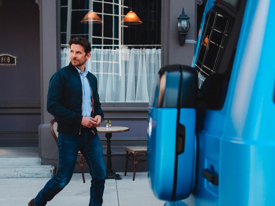 Bradley Cooper walking to a Mercedes-Benz G-Class vehicle