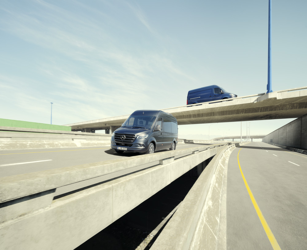 Leasingangebote | Mercedes-Benz Transporter. Ein dunkelgrauer Sprinter Kastenwagen auf einer sonnigen Straße.