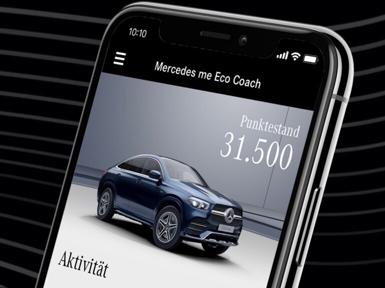 Auf dem Smartphone ist die Mercedes-Benz Eco Coach App geöffnet, und die durch eine besonders umweltfreundliche Fahrweise erreichte Punktzahl wird angezeigt.