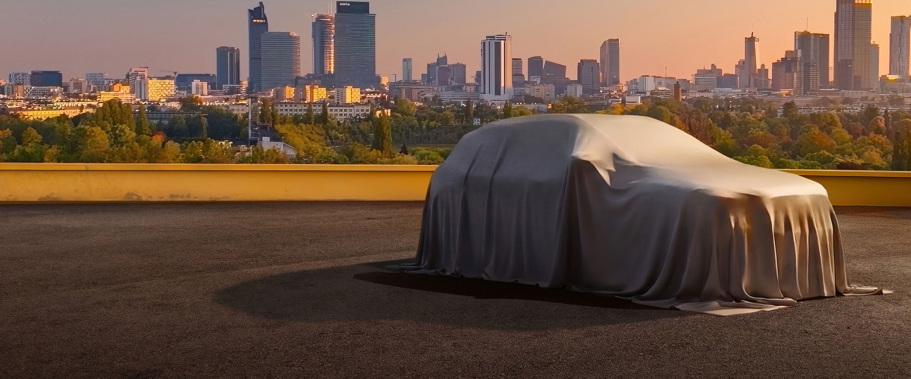 Ein eingehülltes Mercedes-Benz Modell im Sonnenuntergang. Im Hintergrund ist eine Stadt. 