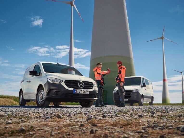 Zwei Transporter von Mercedes-Benz auf einer Baustelle.