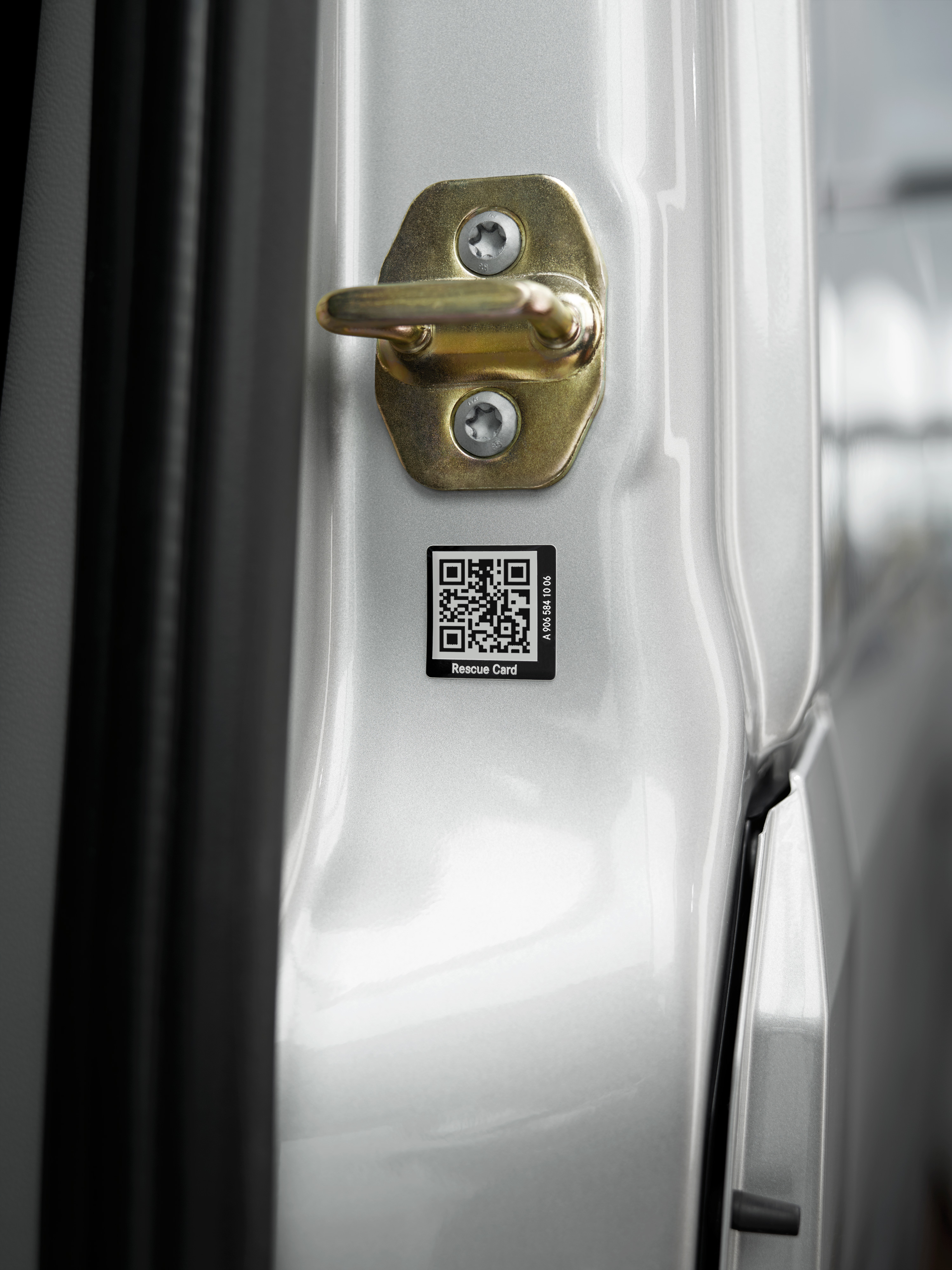 Mercedes-Benz Care | Mercedes-Benz Transporter. Nahaufnahme eines Rettungskarten-Aufklebers mit QR-Code an der Autotür für schnelle Hilfe im Notfall.
